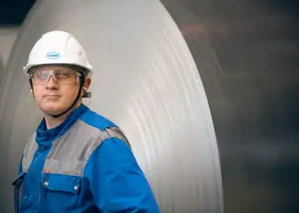 A blue collar worker in a hard hat covered by workers' compensation.