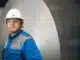 A blue collar worker in a hard hat covered by workers' compensation.